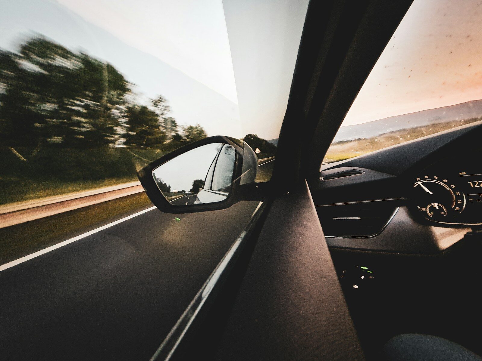 A view of a car's rear view mirror from inside a vehicle