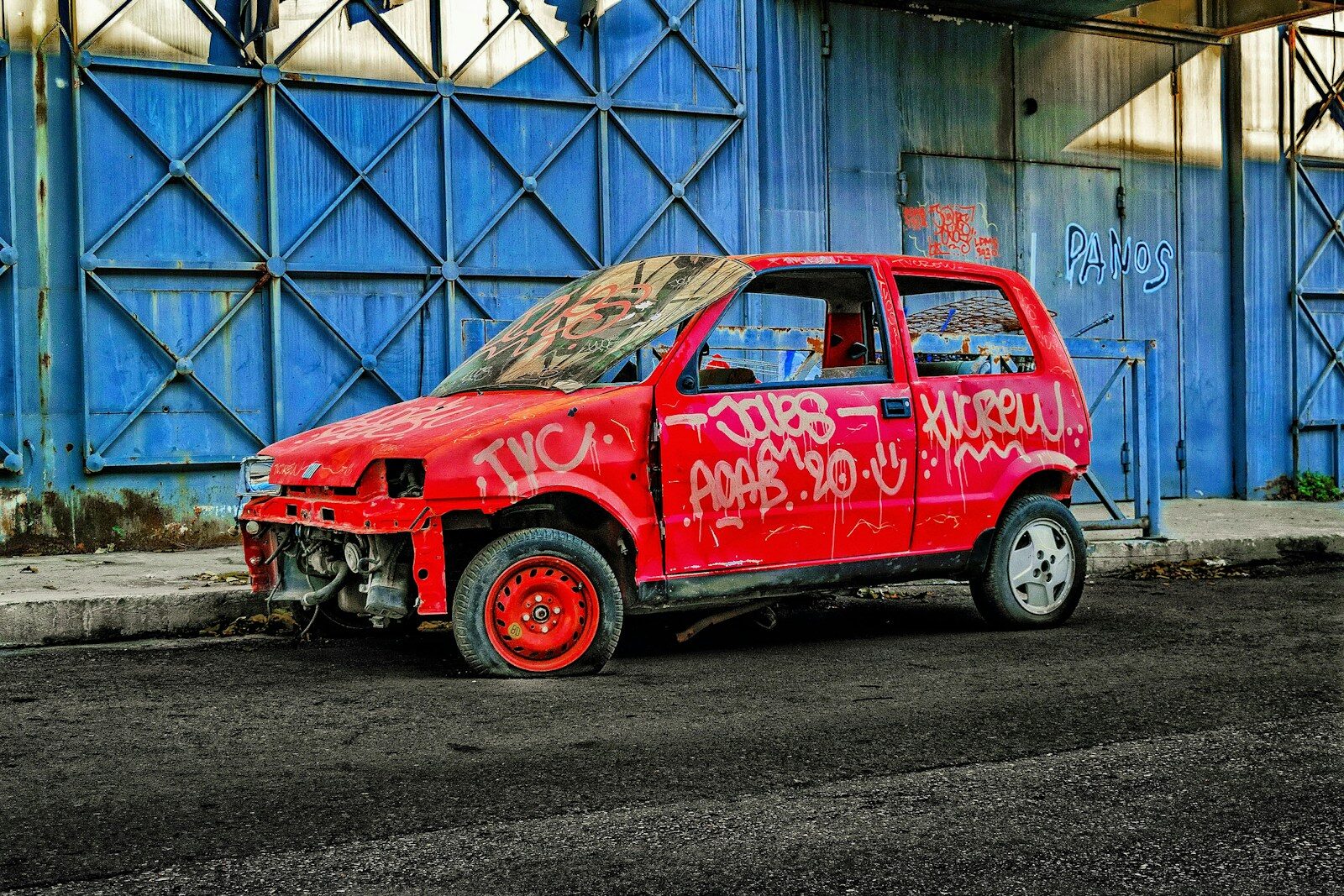 a red car with a dent in the side